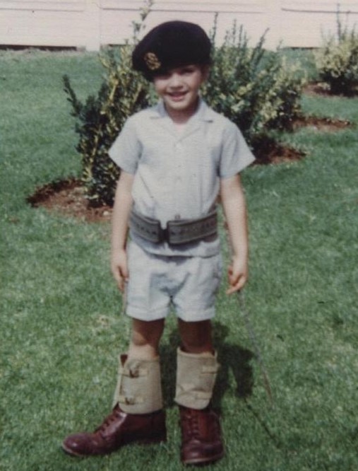 Johan Raath as a young boy wearing a beret and military boots