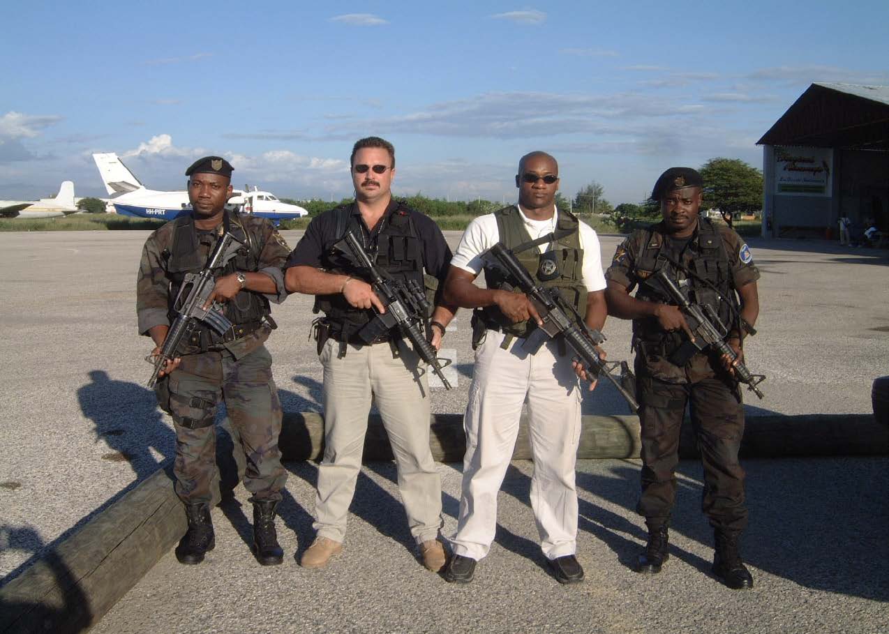 Johan Raath with a protection team beside an aircraft